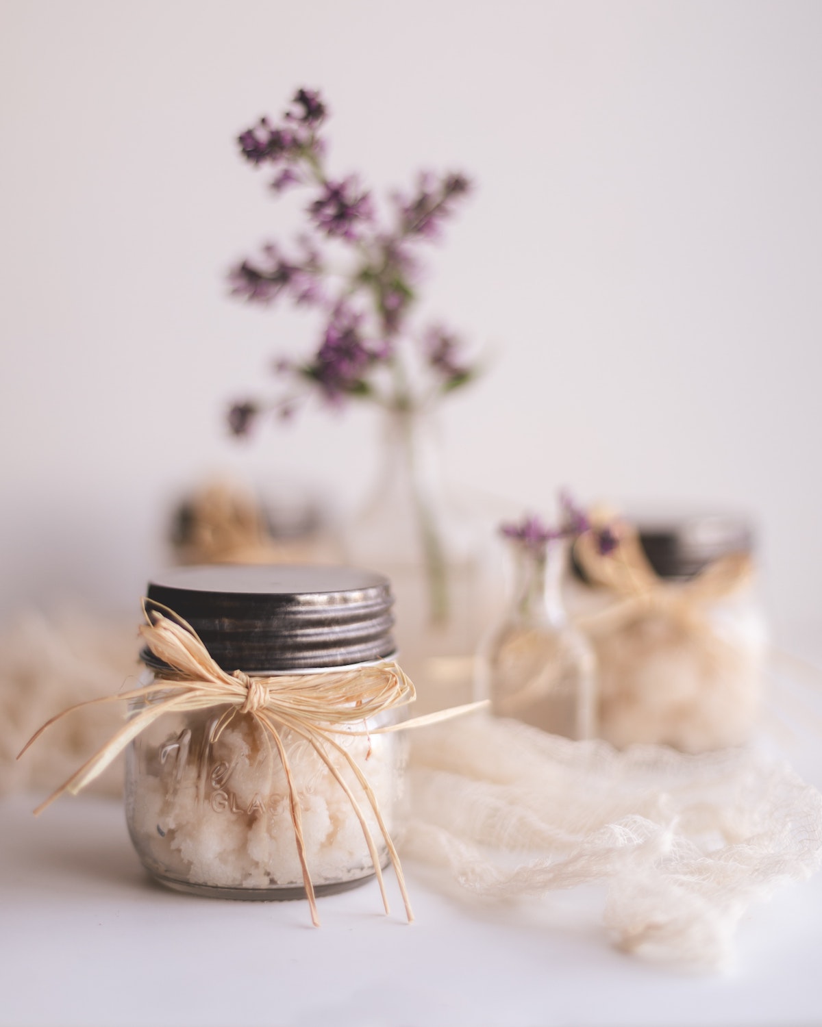 beautiful glass jars with homemade sugar scrub. Lavender flowers.
